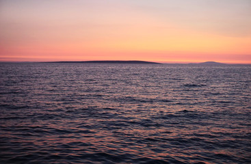 Naklejka na ściany i meble Beautiful sea surface and vivid color horizon and skyline on the summer sunset