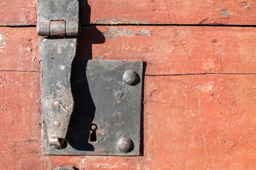Old retro iron latch on vintage wooden case closeup