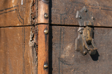 Old weathered retro vintage grunge suitcase handle and metal latch lock closeup