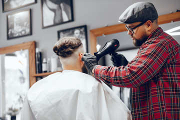 Man with a beard. Hairdresser with a client.