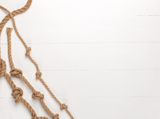 Jute rope on white wooden background.