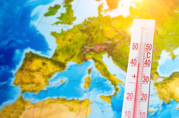 Thermometer with a high temperature of forty degrees Celsius, against the background of continent...