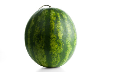 Round watermelon with a tail isolated on white background. Popular fruit. Selective focus.