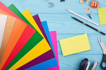 Color papers on the wooden blue desk