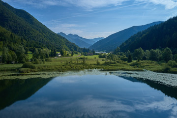 Aerial photography. Panoramic view of a small lake north of Italy. Trento region. Great trip to the lake in the Alps.