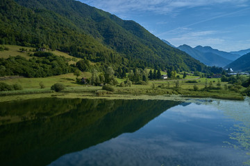 Naklejka na ściany i meble Aerial photography. Panoramic view of a small lake north of Italy. Trento region. Great trip to the lake in the Alps.