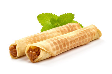 Wafer rolls with condensed milk, homemade sweets, isolated on white background