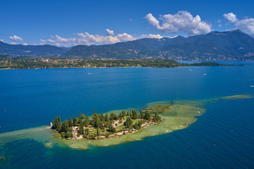 Obraz premium Unique view of the island of San Biagio. In the background is the Alps. Resort place on Lake Garda north of Italy. Aerial photography. 