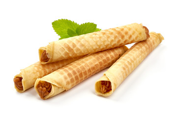 Wafer rolls with condensed milk, homemade sweets, isolated on white background