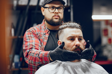 Man with a beard. Hairdresser with a client.