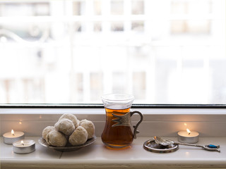 Close up tea and nastar sitting on window sill
