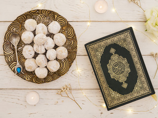 Top view closed quran with pastries