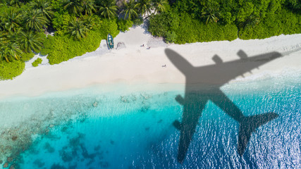 Travel concept with airplane shadow and beach