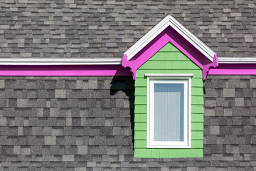 Pink and green window against grey wall