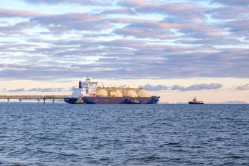 Ocean tanker and several sea tugs