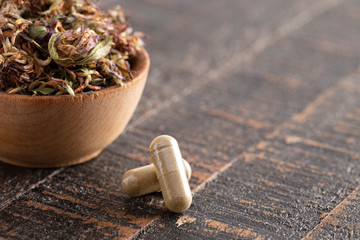 Dried Red Clover Flowers and Leaves on a Wooden Table