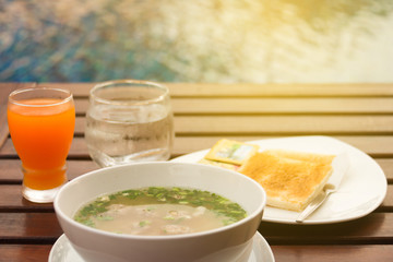 Breakfast by the pool : boiled rice, toast and orange juice.