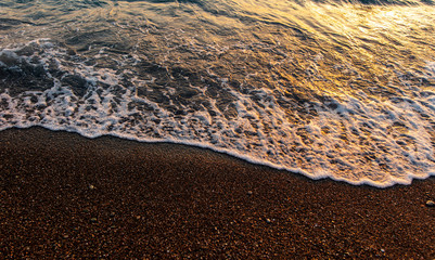 Waves on the seashore at sunset