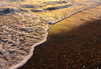 Waves on the seashore at sunset