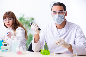 Two chemists working in the lab