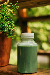 Mango smoothie in a glass Mason jar and mango on a green background. shake. Tropical fruit concept.