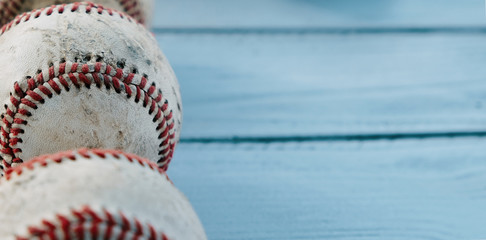 Baseball game balls close up on wood background with copy space.