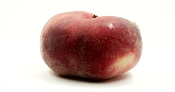 Donut peach with googly eyes on white background. Crazy funny fruit. Fruit face isolated rotation. Funny face rotates on itself.