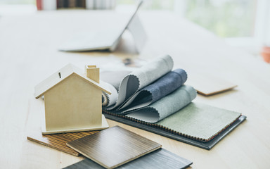 Architect and home interior decorator desktop with tools, wood swatches and home project decoration.