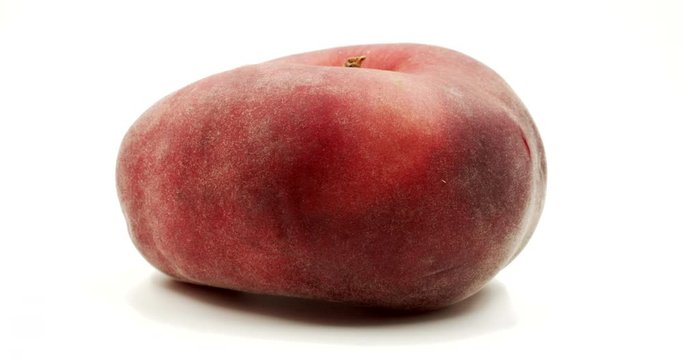 Donut peach with googly eyes on white background. Crazy funny fruit. Fruit face isolated rotation. Funny face rotates on itself.