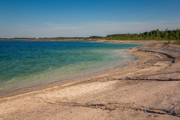 Azure lake called Osadnik Gajowka near Psary village, Poland