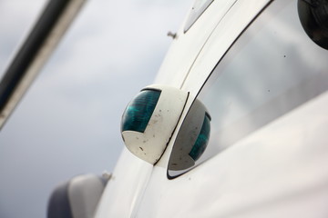 Green navigation light on right board of motor boat close up