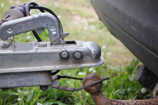 Towing a car trailer, hitch removed from the rusty ball towbar