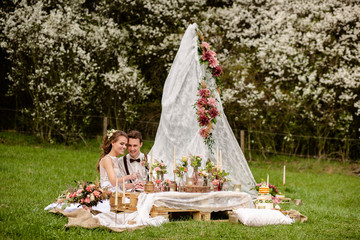 bride and groom sitting on grass
