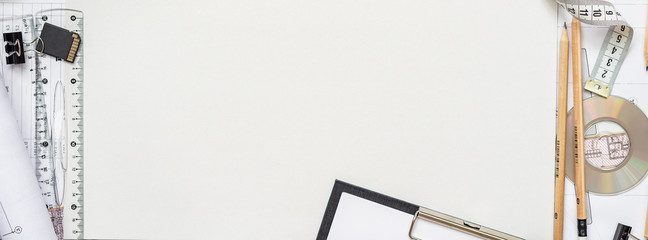 Architectural plans, pencil and ruler on the table. Laptop and accessories. Place for your text.