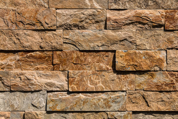 The texture of the wall is made of brown natural stone blocks.