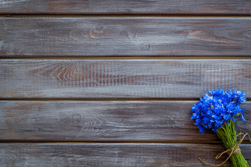 Bouquet of blue cornflowers on wooden background top view mockup