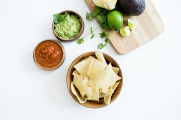 Chips with salsa and guacamole on white background