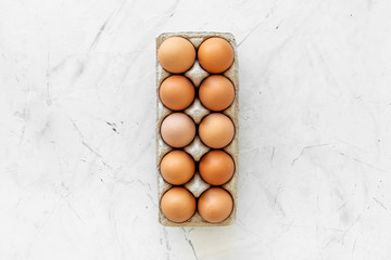 Fresh eggs for organic food on marble background top view