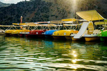 Fototapeta na wymiar On the Kournas lake shore of a beautiful lake situated hire catamarans