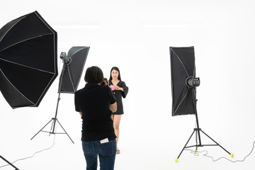 Women photographers are shooting  Asian pretty women in the studio with lighting equipment, To get a perfact and beautiful image, to beauty fashion concept.