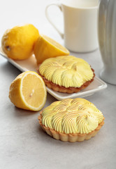 Tartlets with lemon cream on a white table.