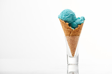 delicious sweet blue ice cream in crispy waffle cone isolated on white