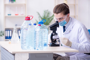 Young male chemist experimenting in lab