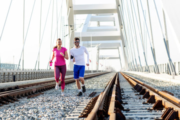 Couple jogging at the bridge