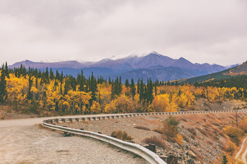 Alaska road trip in Autumn. Highway with mountains in background.