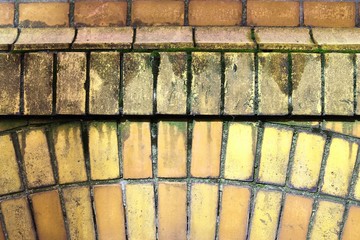 Yellow brick walls with old and weathered stones and cracks im high resolution