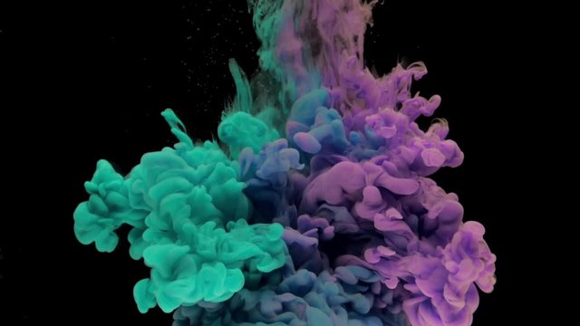 Colorful turquoise and violet ink drops from above mixing in water, swirling softly underwater on black background with copy space. Acrylic cloud of paint isolated. Abstract smoke explosion animation.
