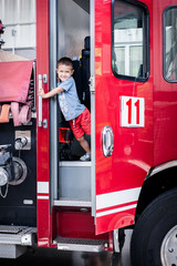 Little Boy On Red Fire Engine