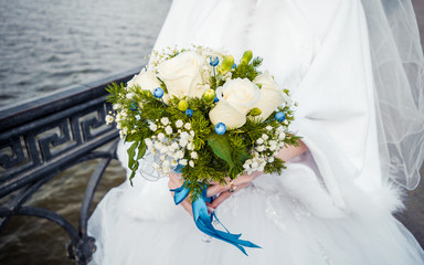 Lush bridal bouquet near the water