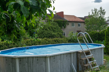 Stockholm Sweden - June 12, 2018: Above ground swimming pool in garden near the house. Circa...